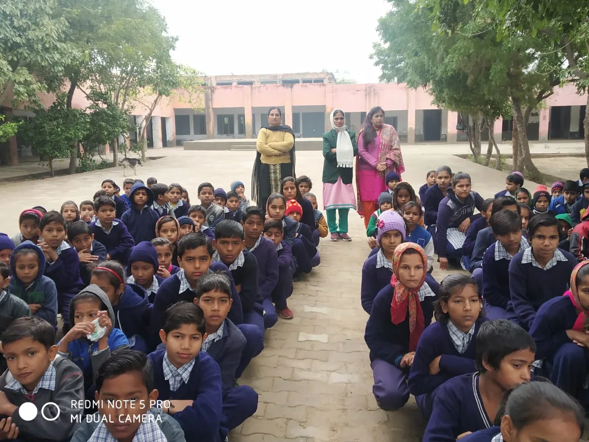 Schoolchildren in winter uniforms sitting in rows